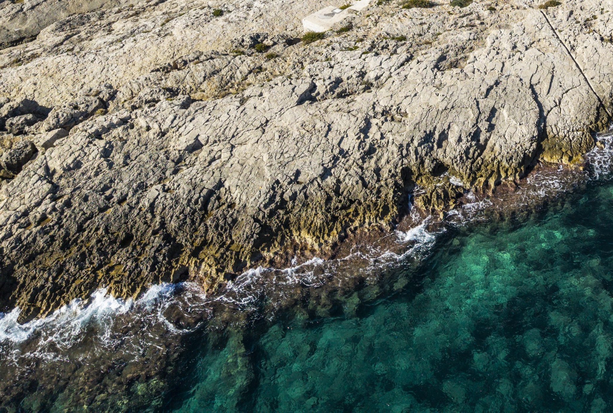 Turquoise water among the rocks of Capo Santa Croce